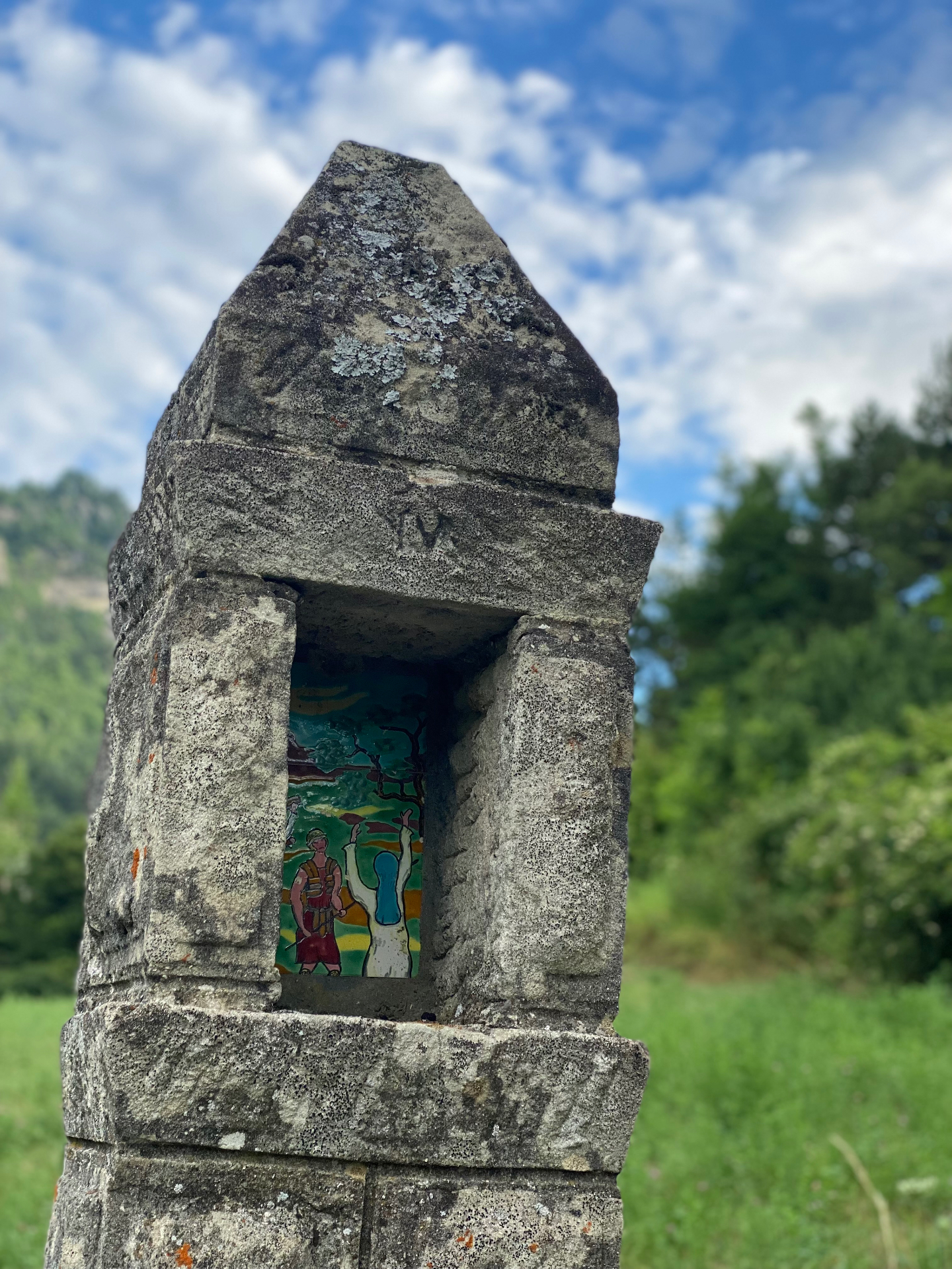 Quatrième station du chemin conduisant à la chapelle Notre-Dame de Vers-la-Ville : oratoire de pierre abritant une plaque émaillée